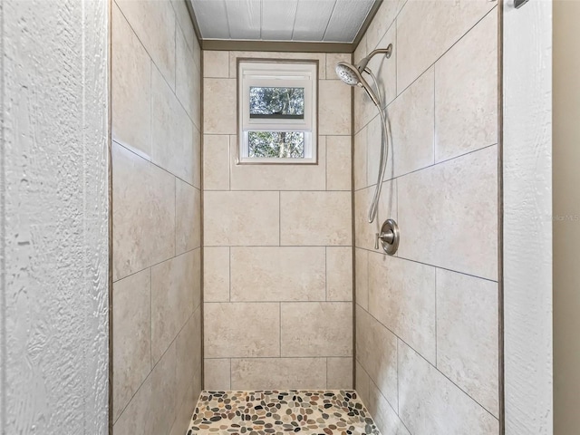 full bath with a tile shower