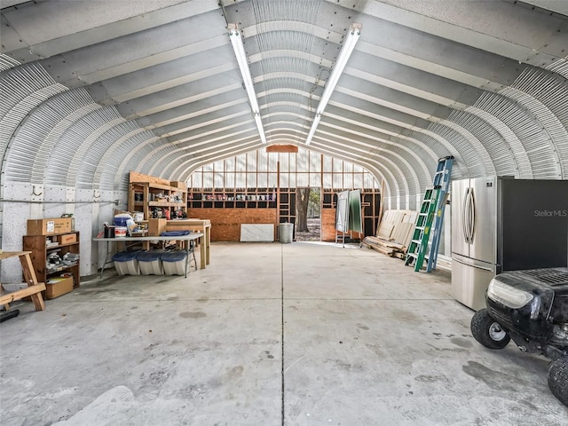 miscellaneous room featuring concrete flooring and vaulted ceiling