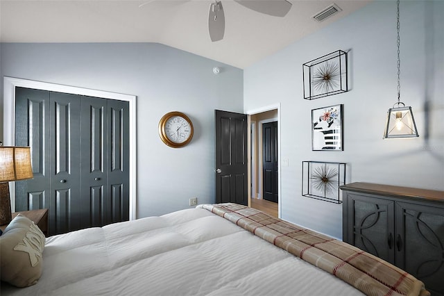 bedroom with lofted ceiling, a ceiling fan, visible vents, and a closet