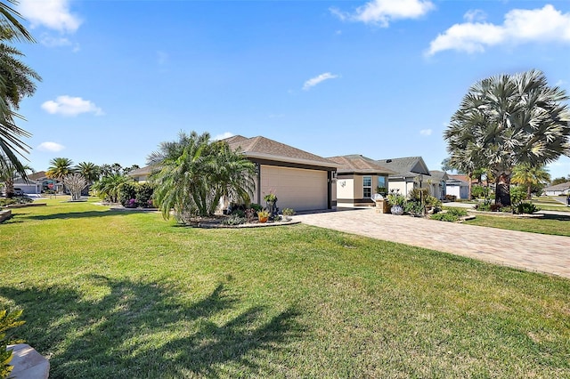 view of front of property with a garage, decorative driveway, and a front yard