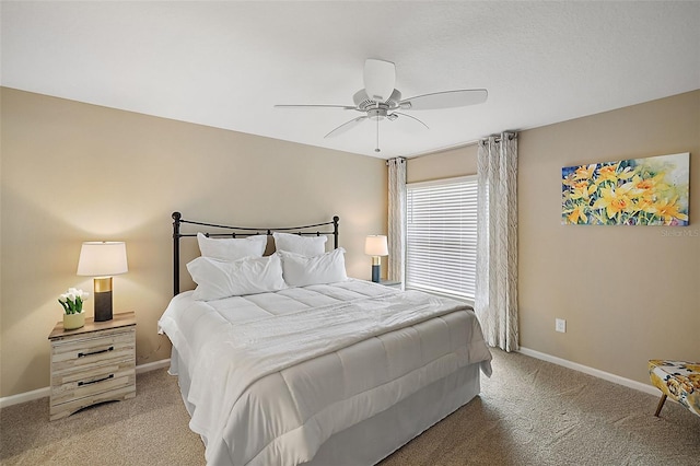 bedroom featuring light carpet, baseboards, and a ceiling fan