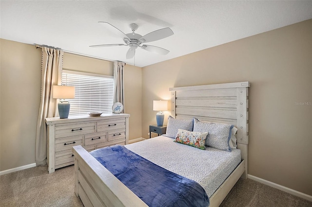 bedroom featuring light carpet, ceiling fan, and baseboards