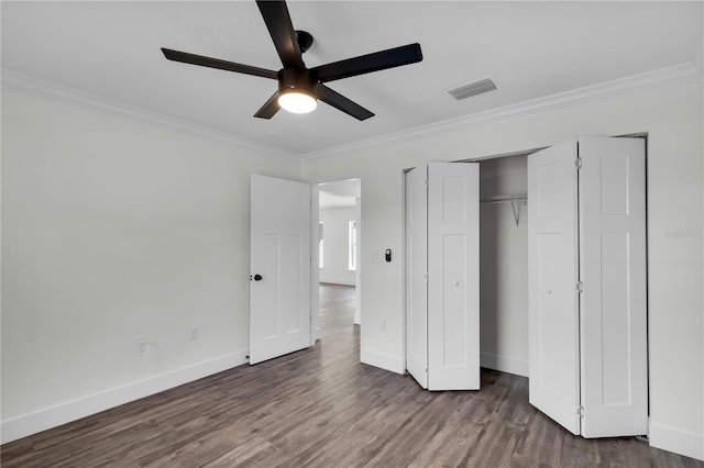 unfurnished bedroom with baseboards, visible vents, wood finished floors, and ornamental molding