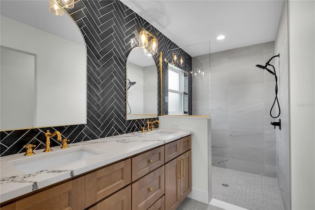 bathroom featuring double vanity, backsplash, a walk in shower, and a sink