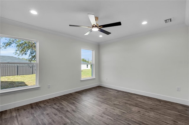 spare room with visible vents, crown molding, and baseboards