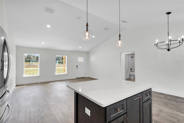 kitchen with baseboards, visible vents, light countertops, and wood finished floors