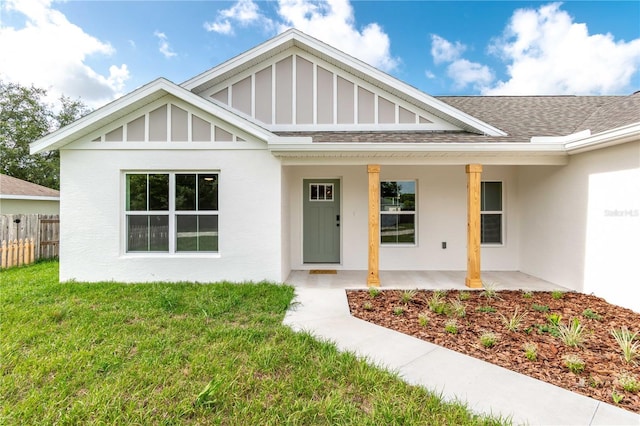 13334 SW 107th St, Dunnellon, FL 34432 - view of front of house featuring a shingled roof, stucco siding, a porch, and board and batten siding