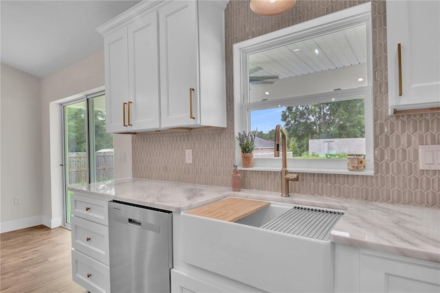 13334 SW 107th St, Dunnellon, FL 34432 - kitchen featuring dishwasher, decorative backsplash, and white cabinetry