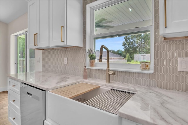 13334 SW 107th St, Dunnellon, FL 34432 - kitchen with dishwasher, backsplash, white cabinets, and light stone counters