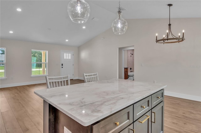 13334 SW 107th St, Dunnellon, FL 34432 - kitchen featuring lofted ceiling, light wood-style floors, a chandelier, a kitchen island, and hanging light fixtures