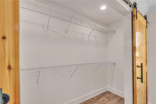 13334 SW 107th St, Dunnellon, FL 34432 - walk in closet with light wood-type flooring and a barn door