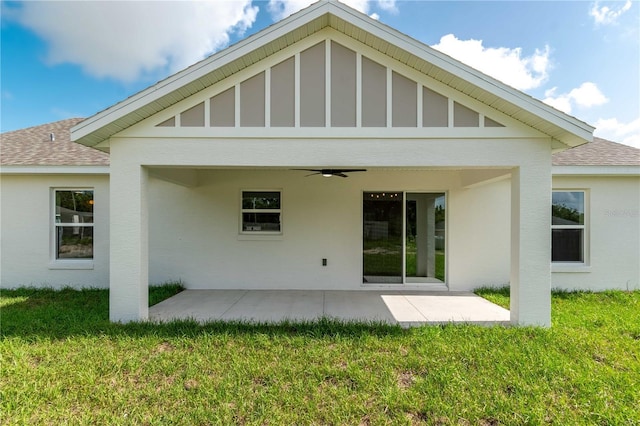13334 SW 107th St, Dunnellon, FL 34432 - back of property with a shingled roof, a ceiling fan, a patio area, and a lawn
