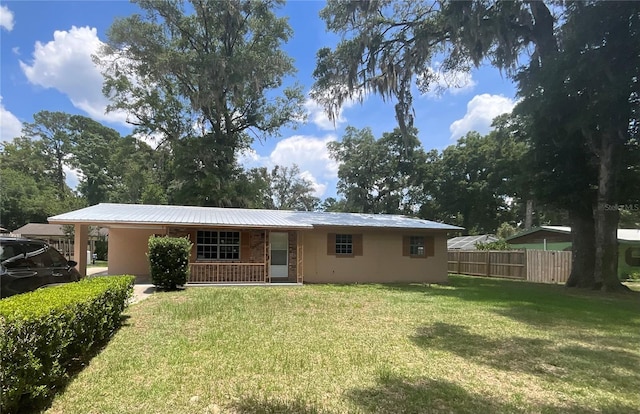 back of house with fence, a porch, a yard, and metal roof