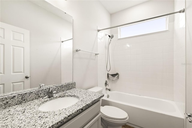 bathroom featuring bathtub / shower combination, toilet, and vanity