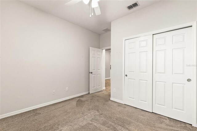 unfurnished bedroom with a closet, visible vents, baseboards, and carpet