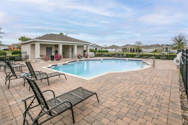 pool featuring a patio area and fence