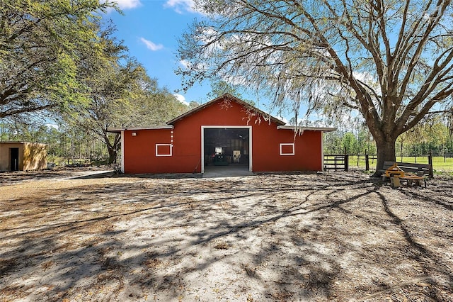 view of outbuilding with an outbuilding and fence