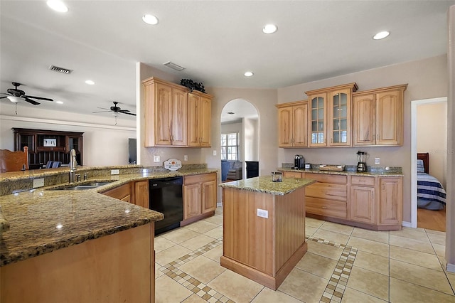 kitchen with arched walkways, dishwasher, light stone counters, a sink, and recessed lighting