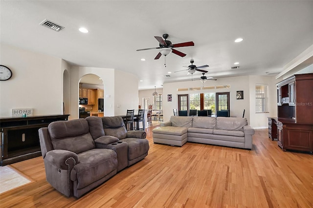 living room with light wood-style floors, recessed lighting, and visible vents