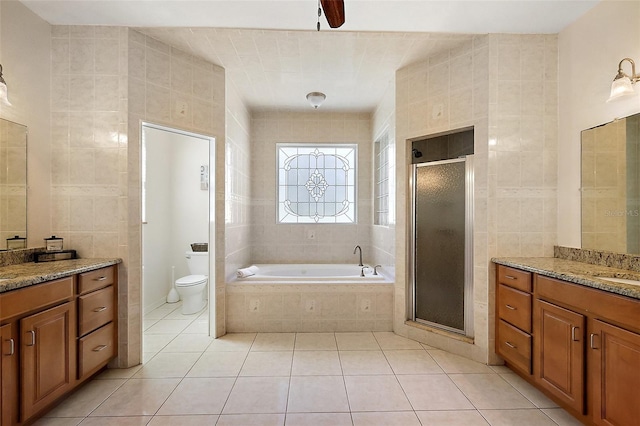 bathroom featuring a stall shower, tile patterned flooring, and tile walls