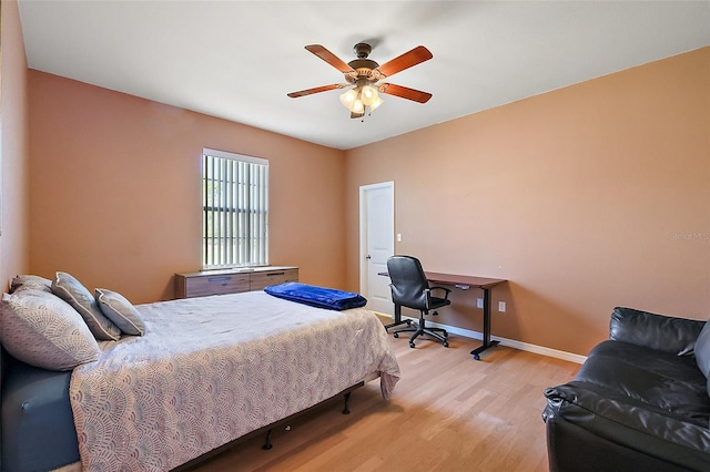 bedroom featuring ceiling fan, light wood-style flooring, and baseboards