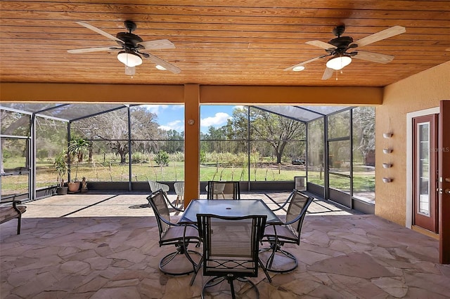 unfurnished sunroom with wood ceiling and ceiling fan