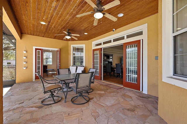 view of patio featuring outdoor dining area and a ceiling fan