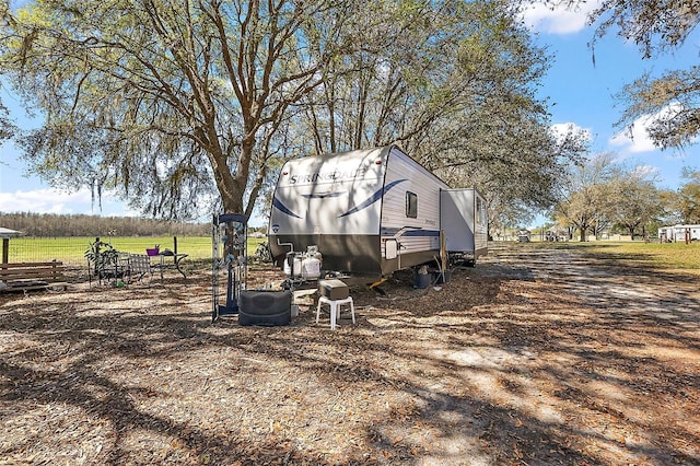 view of property exterior with an outbuilding and a rural view