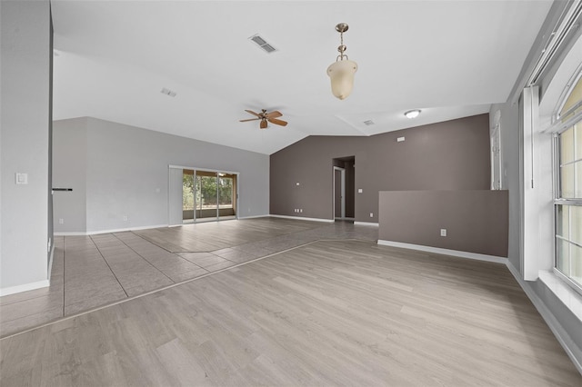 unfurnished living room with a ceiling fan, lofted ceiling, wood finished floors, and visible vents