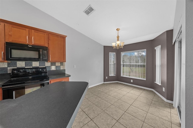 kitchen featuring dark countertops, visible vents, vaulted ceiling, light tile patterned floors, and black appliances