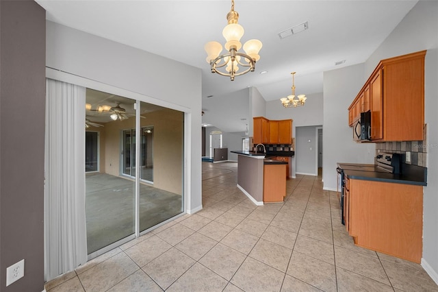 kitchen featuring visible vents, range with electric stovetop, dark countertops, black microwave, and light tile patterned floors
