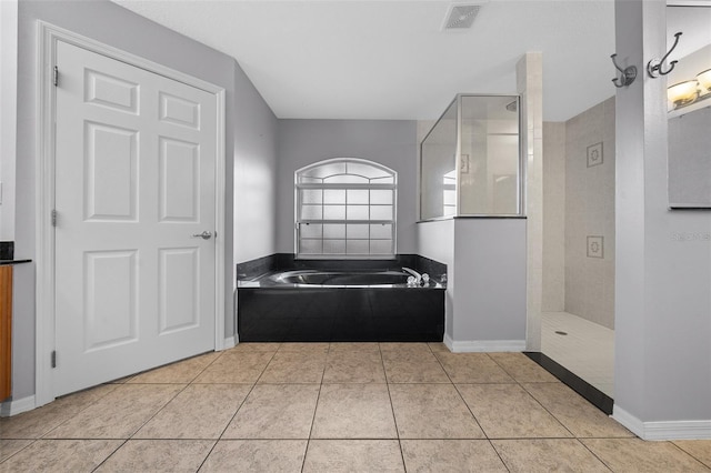 bathroom featuring visible vents, baseboards, walk in shower, a bath, and tile patterned floors
