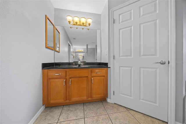 bathroom with tile patterned flooring, vanity, and baseboards