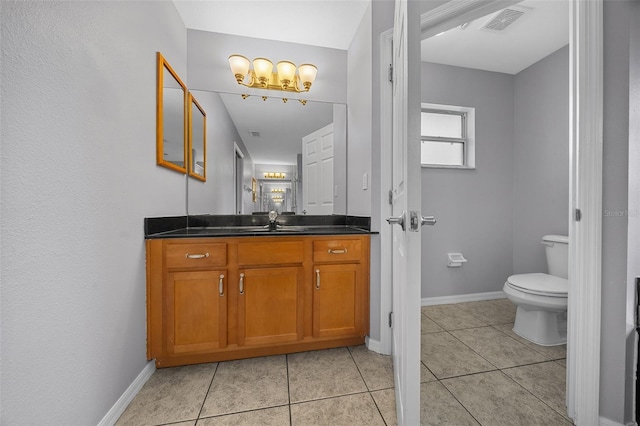 bathroom featuring vanity, tile patterned floors, baseboards, and visible vents