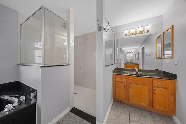 full bath with tile patterned floors, baseboards, walk in shower, a bath, and vanity