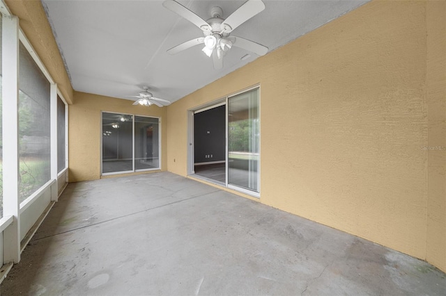 unfurnished sunroom with a ceiling fan