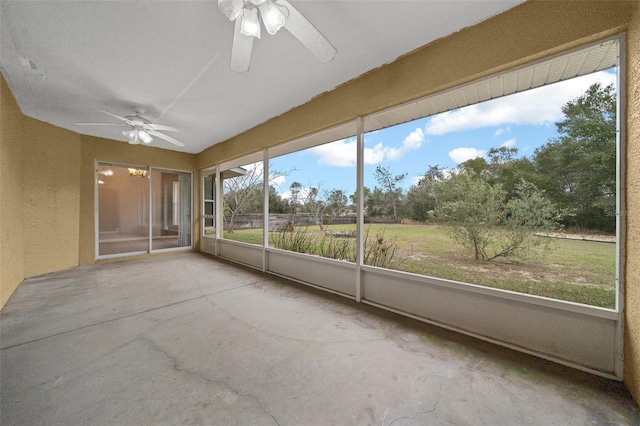 unfurnished sunroom featuring a ceiling fan