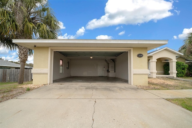 exterior space with concrete driveway and fence