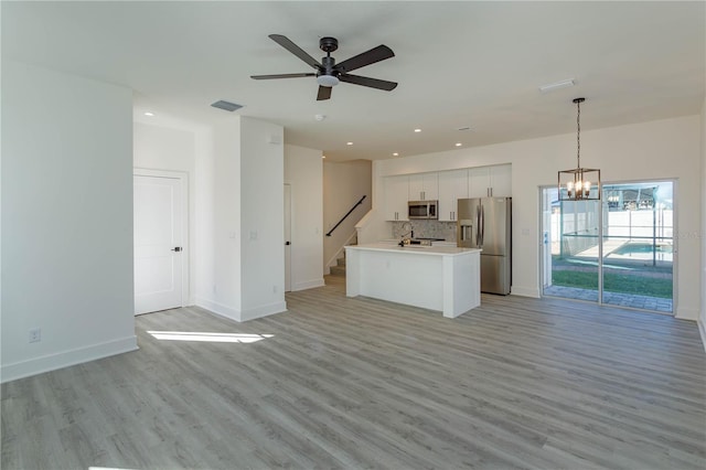 unfurnished living room with recessed lighting, visible vents, light wood-style flooring, and baseboards