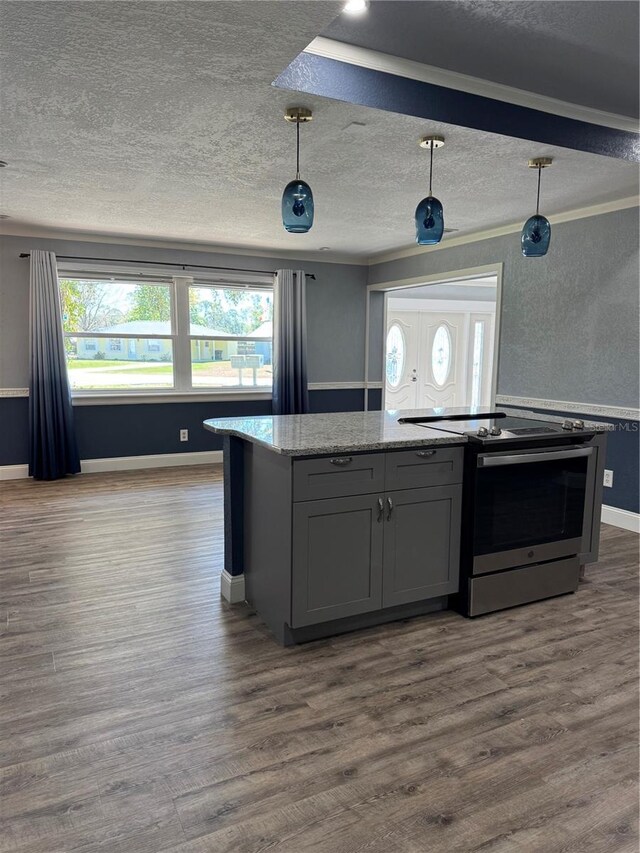 kitchen with stainless steel electric range oven, a textured ceiling, light stone counters, and dark wood-type flooring