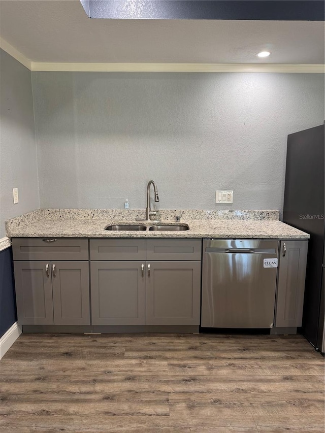 kitchen with dishwasher, wood finished floors, gray cabinets, and a sink