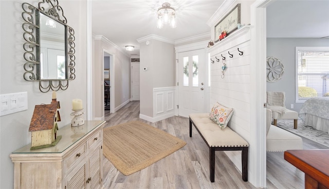 mudroom featuring ornamental molding and light wood-style flooring