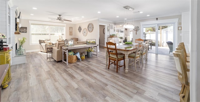 dining space featuring ornamental molding, light wood-type flooring, baseboards, and recessed lighting