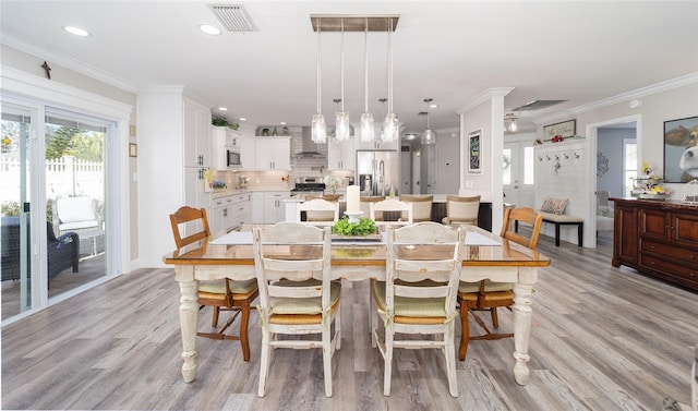 dining area featuring ornamental molding, recessed lighting, visible vents, and light wood-style floors