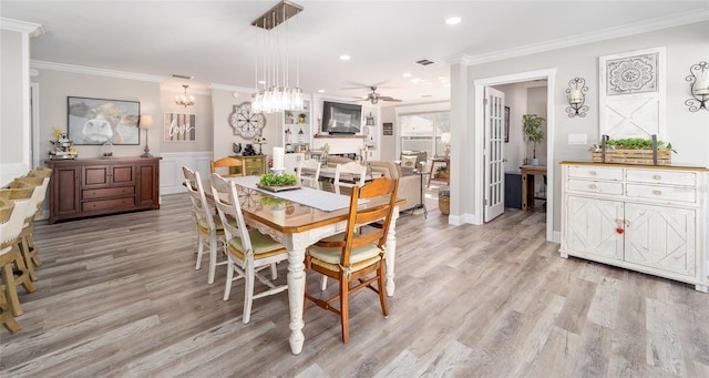 dining room with crown molding, light wood finished floors, recessed lighting, visible vents, and ceiling fan with notable chandelier