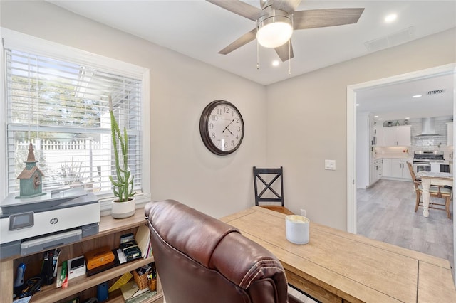 office space with ceiling fan, light wood-type flooring, visible vents, and recessed lighting