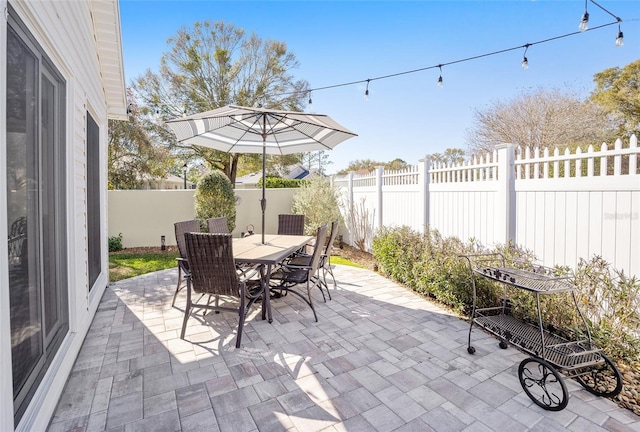 view of patio with a fenced backyard and outdoor dining area