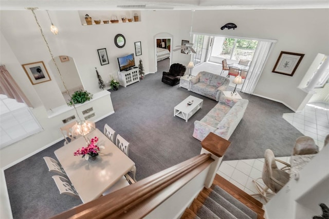 carpeted living area featuring a fireplace and stairway