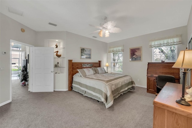 bedroom featuring multiple windows, visible vents, and light colored carpet