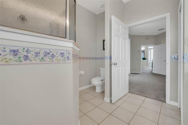 bathroom featuring toilet, baseboards, visible vents, and tile patterned floors